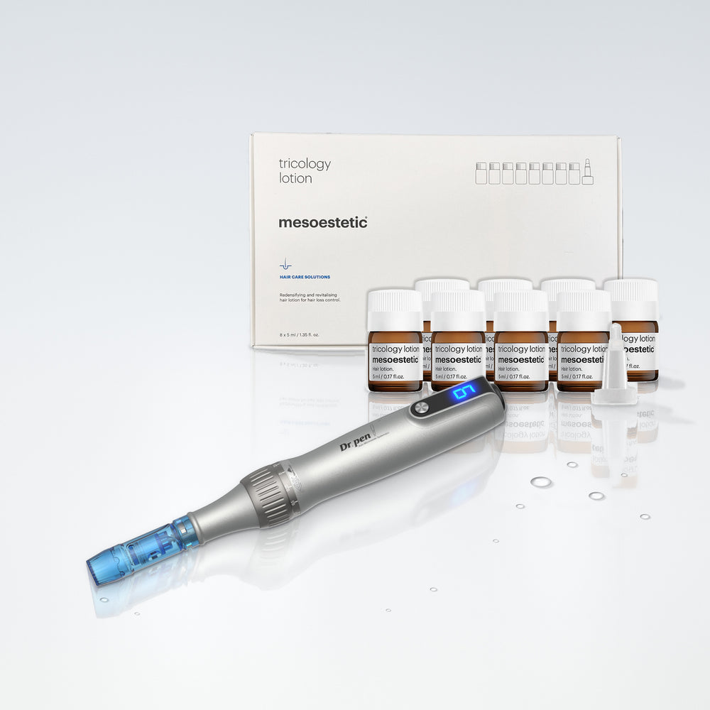 Dr. Pen M8S microneedling pen with the mesoestetic tricology lotion box and 8 vials on a glass surface with water droplets